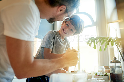 Buy stock photo Bonding, father and son in kitchen with whisk, cooking together or teamwork for breakfast meal prep. Happy, boy child and parent help in home with food, recipe or collaboration for skills development