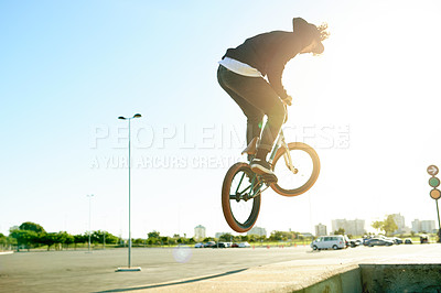 Buy stock photo Bike, air and man with trick in city with lens flare, jump or stunt for extreme sports outdoor. Skill, action and person on bicycle for fitness, cyclist challenge or rider with talent in urban park