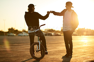 Buy stock photo Fist bump, happy and men with bicycle, sunset or commuting with transport on road, gesture and trip. Outdoor, cyclist and friends with eco friendly bike, greeting and journey on urban street or city