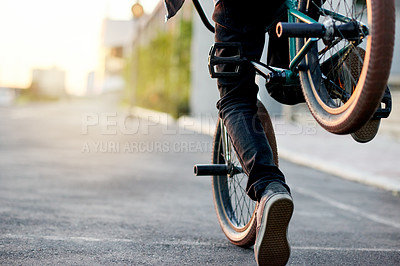 Buy stock photo Legs, city and person on bike for trick in street, shoes for stunt or skill outdoor with extreme sports. Cyclist, rider and bicycle for urban challenge, performance or action in road with space