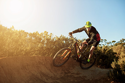 Buy stock photo Man, cycling and mountain bike with sunset on dirt track for adrenaline rush, fitness or extreme sport in nature. Male person, cyclist or riding with bicycle for cardio workout on path, road or trail