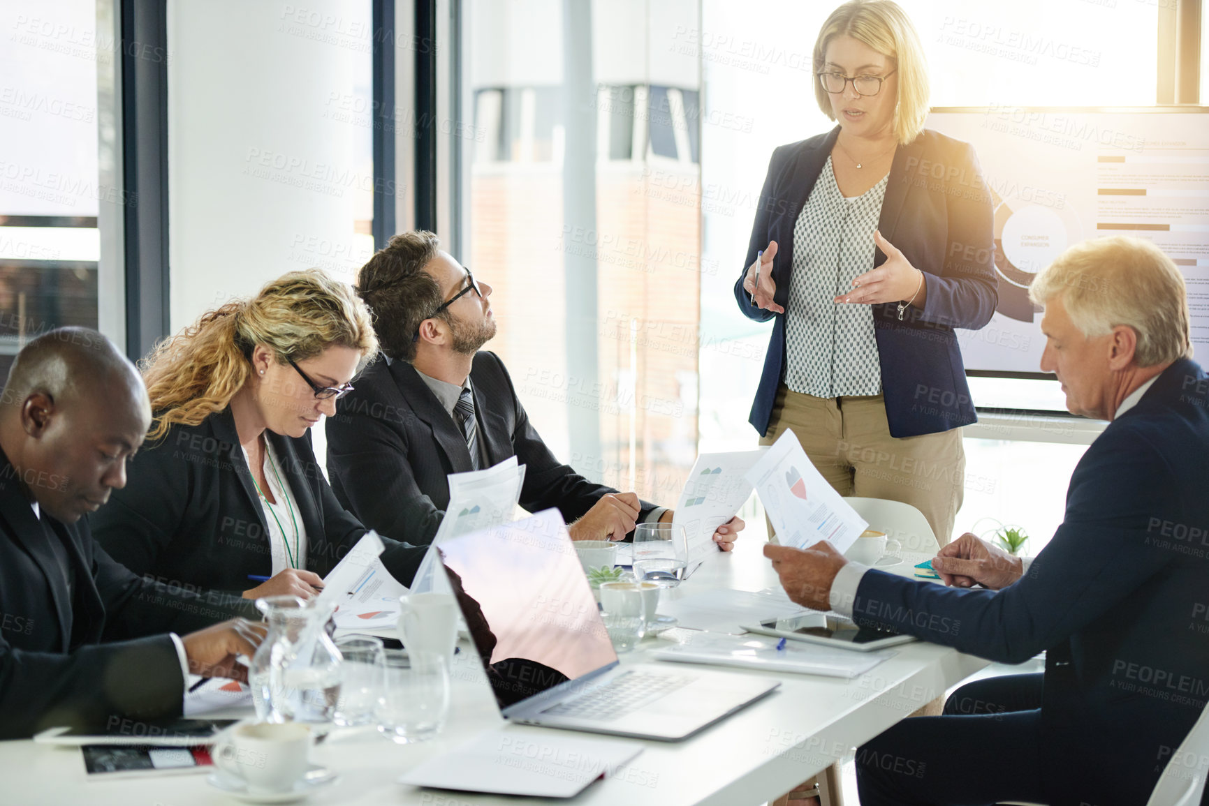 Buy stock photo Boardroom, presentation and woman with team, talking and financial strategy with paperwork for info. Reading, document and accountant with project update, graph or  meeting for investment opportunity