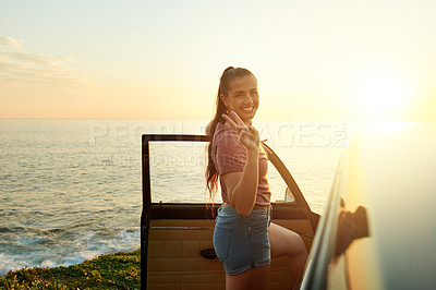 Buy stock photo Portrait, peace sign and woman with car, ocean or tourist in nature with vehicle, space or sunshine. Outdoor, road trip and person with transport for adventure, happy and confident on summer vacation
