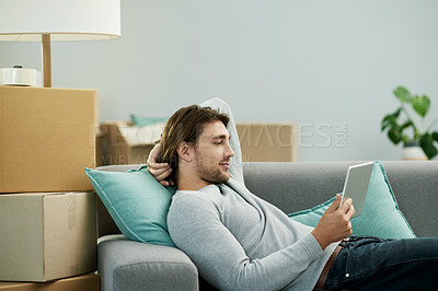 Buy stock photo Relax, moving and man with tablet, home and research for renovation of apartment, online or website. Relocation, boxes and person with tech for house improvement, browsing or info for interior design