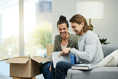 Buy stock photo Boxes, book and couple on sofa, unpacking and homeowner with relationship, real estate and smile. Rental apartment, happy man and woman on couch, literature and relax with novel, love and relocation