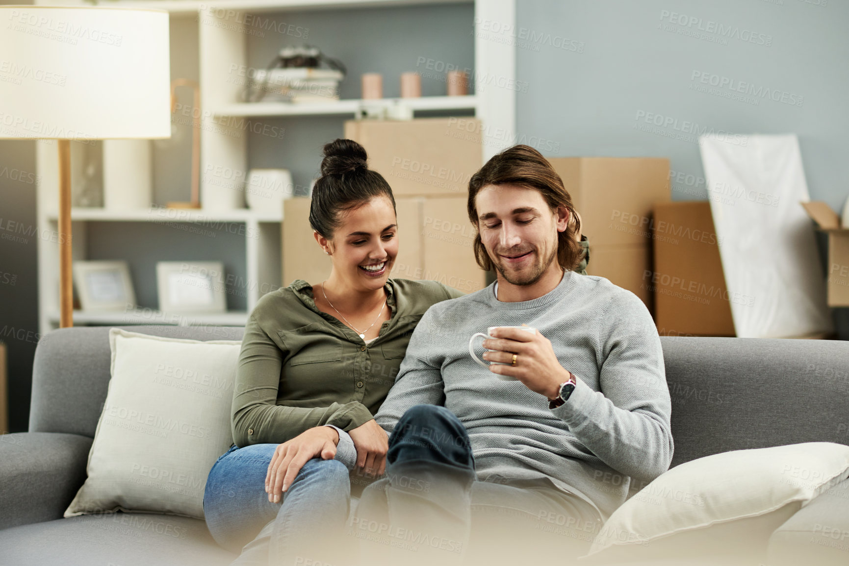 Buy stock photo Coffee, real estate and relax with couple on sofa in living room of new home together for mortgage. Boxes, drink and moving day with happy homeowner people in apartment for growth or property finance