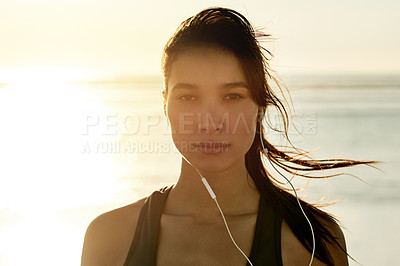 Buy stock photo Portrait, woman and earphones of fitness at beach for exercise, listening to music and training recovery. Female athlete, fatigue and rest with streaming audio, marathon practice and wellness workout