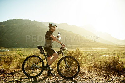 Buy stock photo Water, thinking and bicycle with man in nature for reflection, hydration and cardio workout. Electrolytes drink, vision and cycling training with person and space outdoor for triathlon practice