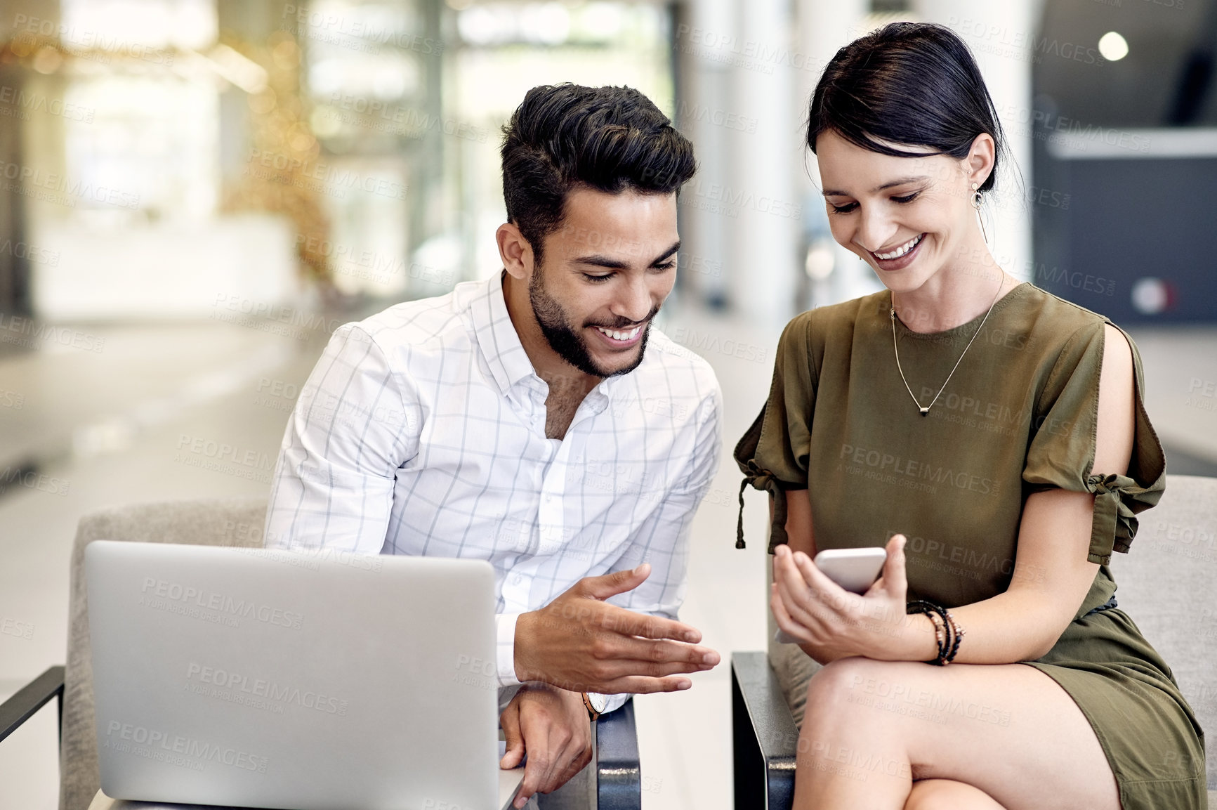 Buy stock photo Phone, colleagues and business people in airport for waiting, summit event or convention. Flight schedule, laptop and man with happy woman in lobby for meme, international conference or travel time