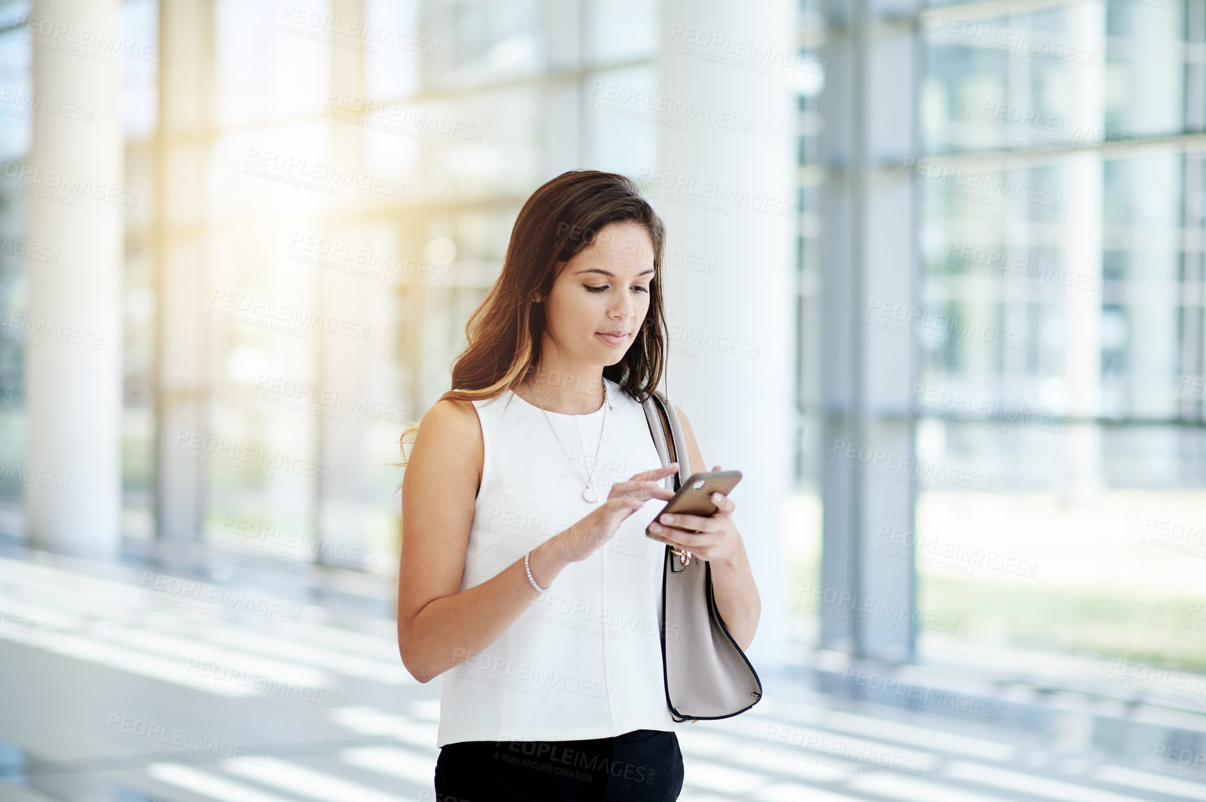 Buy stock photo Phone, text message and walking with woman employee in lobby of workplace for social media. App, communication and typing with business person in office corridor or foyer for feedback or online chat