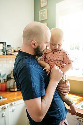 Buy stock photo Father, kitchen and dad care for his kid in a home bonding, relax and feeling calm together in a house. Caring, single parent and man person showing kid happiness, happy and support as way of love