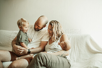 Buy stock photo bond, happy family and parents with baby and toddler on sofa with smile, care and relax in their home together. Newborn, love and mother and father with children in a living room enjoying parenthood