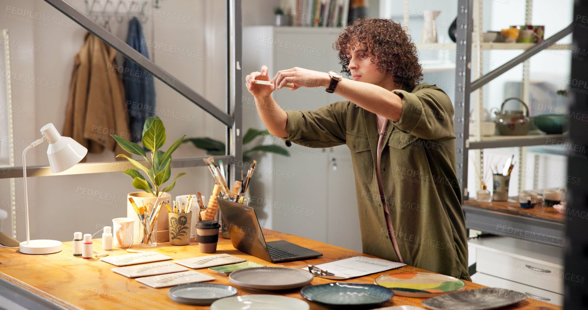 Buy stock photo Pottery, man and picture in shop with phone, website and social media marketing for small business. Person, clay product and photography in store with tech, content creation and post for art seller.