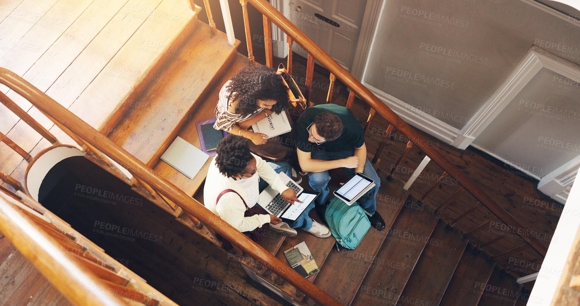Buy stock photo Students, laptop and project in college with collaboration, learning and discussion for stats course. Above, people and study group on stairs with tech, data analytics and university for education.