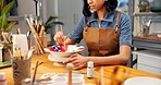 Woman, painting and creativity with clay art workshop, ceramic craft and color in workspace. Paintbrush, artistic process and person with handmade project, pattern and skill development in studio