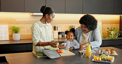 Buy stock photo Packing, lunch and child with family in kitchen for health, help and meal for school in morning. Home, food and African girl with mom, grandma and bag for fruit, vitamins and nutrition for wellness