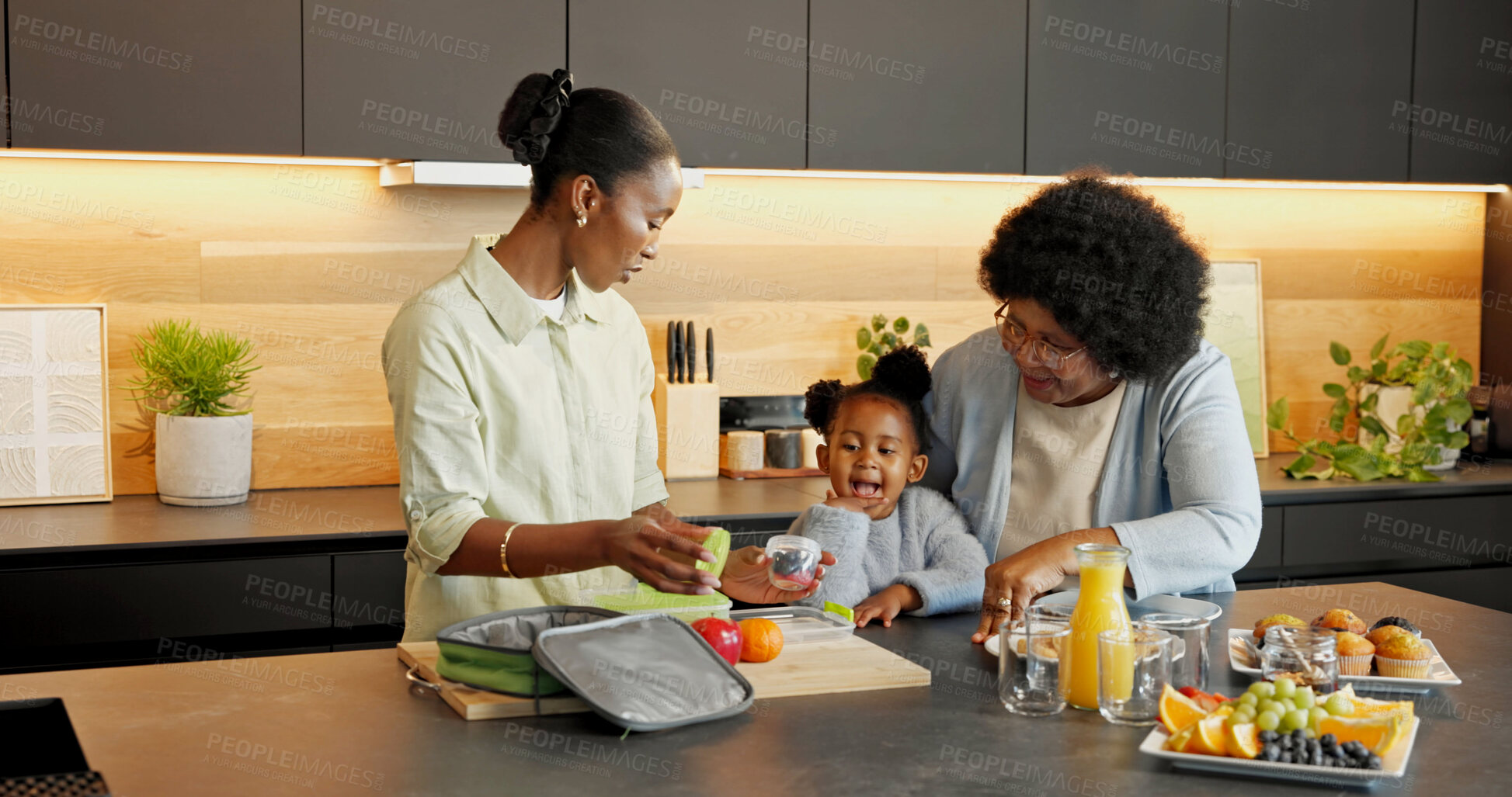 Buy stock photo Packing, lunch and child with family in kitchen for health, help and meal for school in morning. Home, food and African girl with mom, grandma and bag for fruit, vitamins and nutrition for wellness