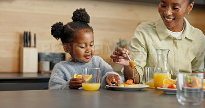 Buy stock photo Happy, kitchen and mom with child for breakfast, healthy eating and meal together in morning. Family, food and African girl with mother, juice and fruit for vitamins, nutrition and wellness in home