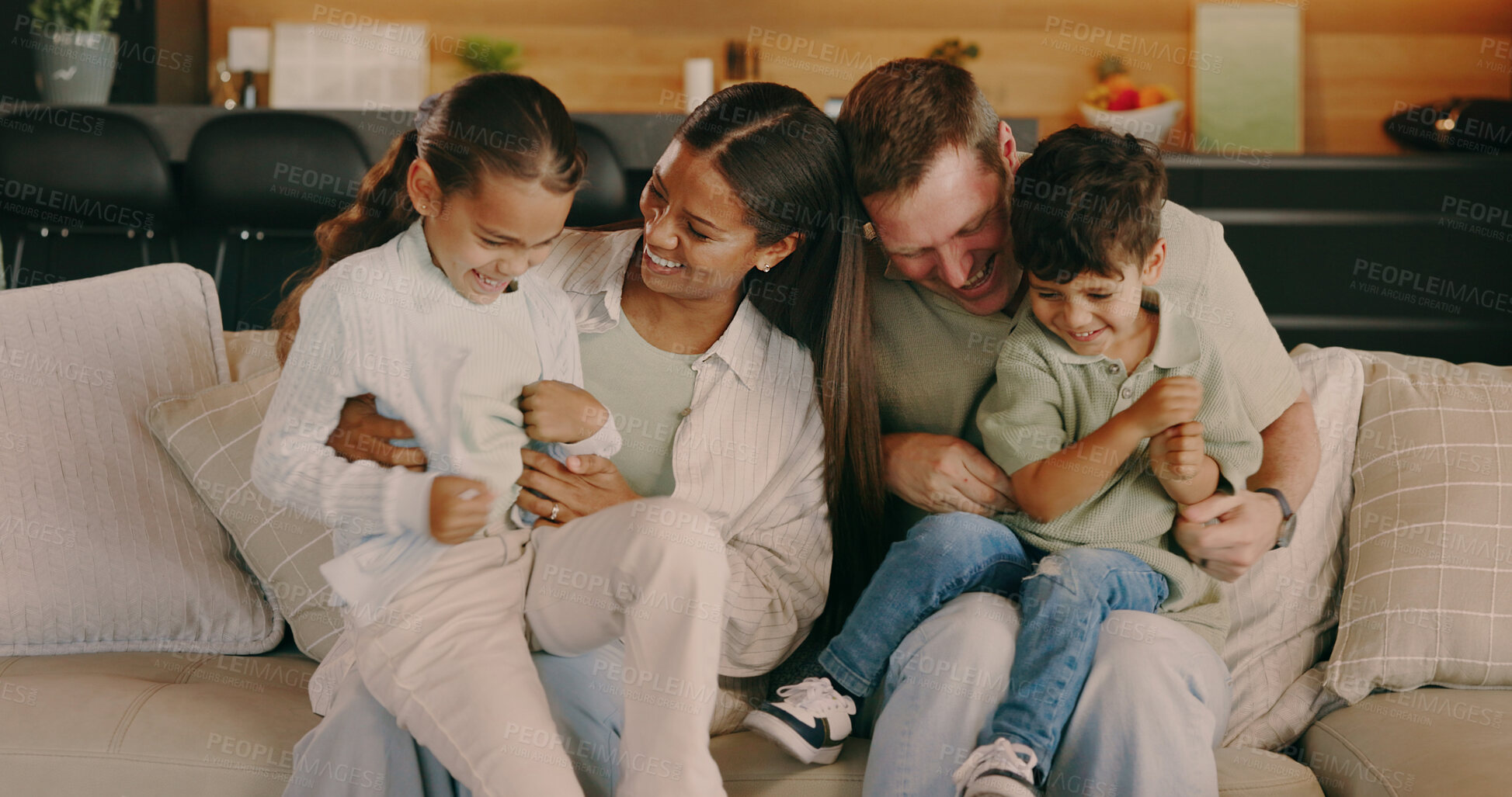Buy stock photo Tickle, laugh and parents with kids on sofa for bonding, playful relationship and connection. Happy, family and children with mom, dad and playing for love, funny moment and relax in home on weekend