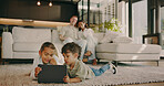 Children, online and relax with tablet, home and watching cartoons with app subscription in lounge. Siblings, bonding and streaming movie with technology, happy and kids with parents in living room