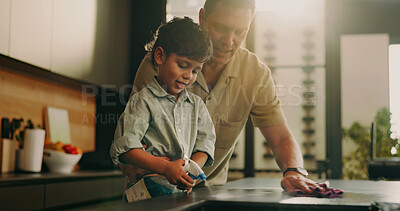 Buy stock photo Dad, child and spray for cleaning, learning and teaching domestic duties with parenting in home. Hygiene, disinfect and man guiding son with detergent, wiping counter or help with kitchen cleanliness