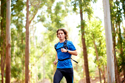 Buy stock photo Running, health and fitness with man in nature for sports athlete, forest trail and marathon training. Wellness, challenge and workout with person or runner in woods for exercise, race and cardio
