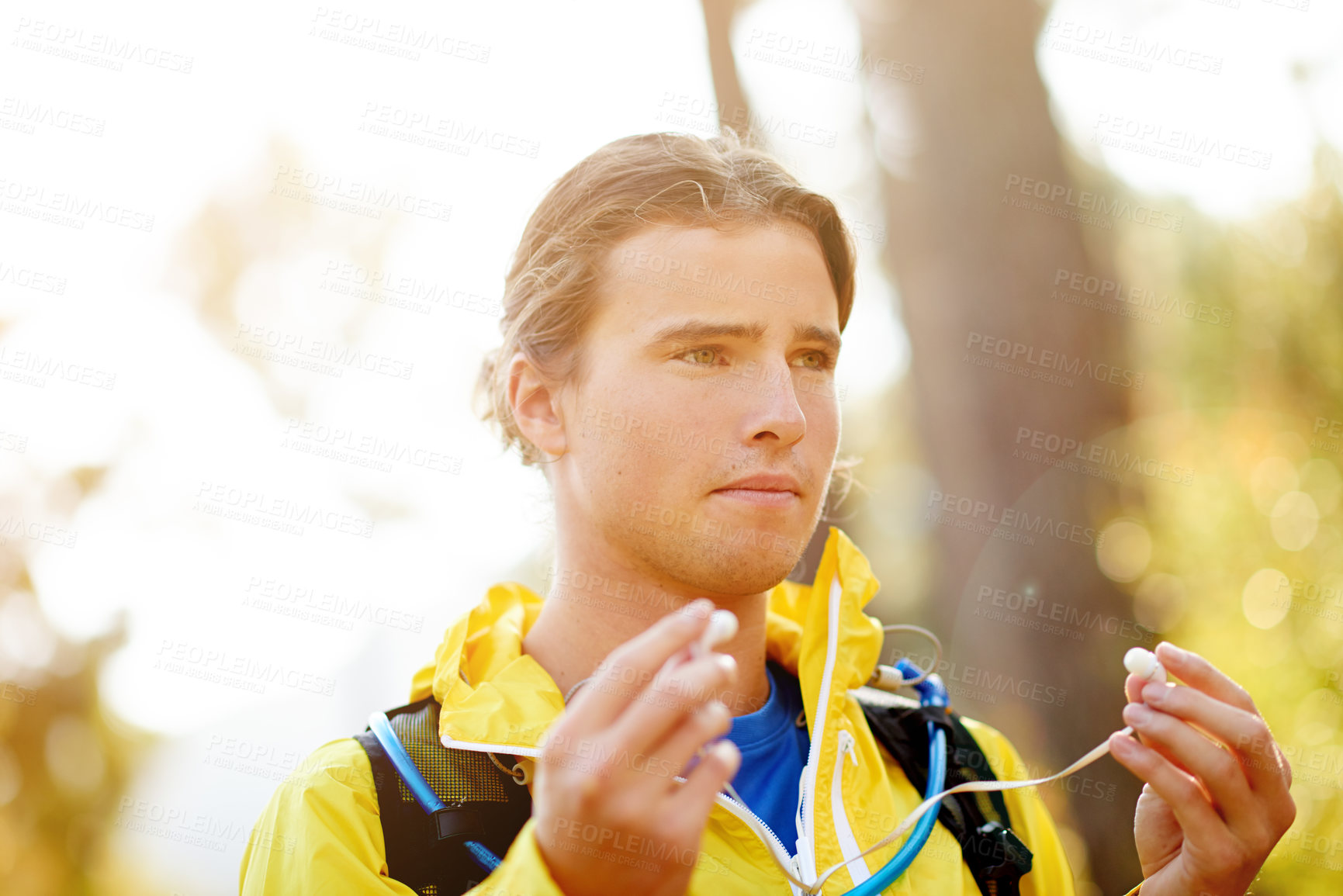 Buy stock photo Fitness, earphones and man at park for music, sports podcast and thinking of playlist on break to relax. Audio, runner and streaming radio outdoor for training, workout and listening to exercise song