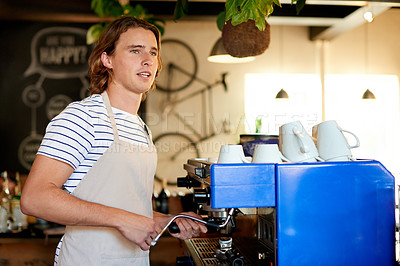 Buy stock photo Startup, barista and man in coffee shop, machine and skills with friendly service, milk foam and talk. Person, small business and employee in cafe, apron and prepare drink with order and morning
