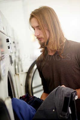 Buy stock photo Man, laundry and clothes washing at laundromat for cleaning service, fresh linen and fabric disinfection. Hygiene, male cleaner and cotton load in electronic appliance for weekly tasks and routine