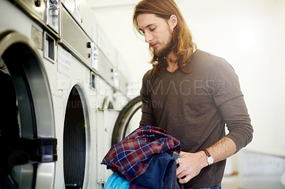 Buy stock photo Man, washing and clothes with machine at laundromat for cleaning service, fresh linen and hygiene. Male person, loading and equipment with laundry, fabric maintenance and preparing for responsibility