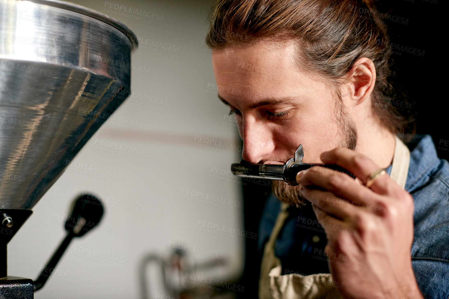 Buy stock photo Roaster, machine and man smell coffee for scent, quality control and inspection in factory. Barista, roasting and aroma in cafe for production process, manufacturing or sniff sample in trier for test