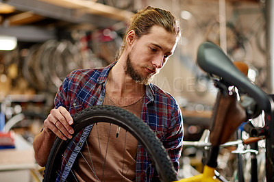 Buy stock photo Man, tyres and bicycle repair at workshop with thinking, equipment and problem solving at small business. Person, technician and bike mechanic with gears, safety check and wheel inspection at garage