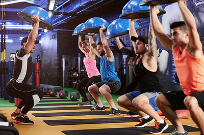 Buy stock photo Instructor, squat or people in gym class with ball exercise for training, workout or core strength. Balance, coach or athlete trainer teaching in club with equipment for fitness, body and support