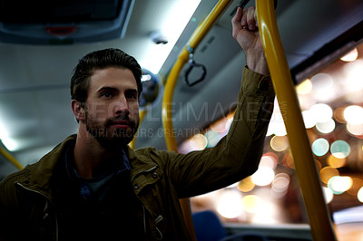 Buy stock photo Man, travel and night with bus for public transportation, local commute or trip in city. Male person, traveler or passenger with handle rail in vehicle for late evening ride or journey downtown