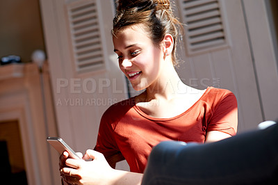 Buy stock photo Phone, happy and girl in home with relax for social networking, online or communication. Smile, technology and female teenager with cellphone for contact, email or chatting on mobile app in house.