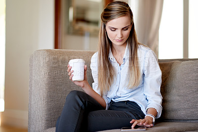 Buy stock photo Woman, typing and tablet on sofa with coffee, social media or planning in home. Girl, student and warm beverage in living room on study break, blog update or idea for creative writing assignment