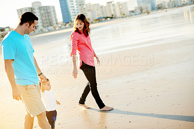Buy stock photo Travel, couple and walking with baby on beach for holiday adventure, bonding together and space. Love, family and holding hands with boy child on seashore for vacation, weekend break and relationship