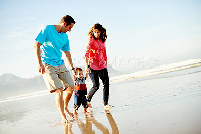 Buy stock photo Toddler, parents and holding hands with walking at beach for bonding, space and travel in nature. People, mom and dad with boy kid, childhood and adventure by sea with family vacation in Argentina