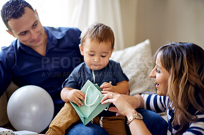 Buy stock photo Birthday, parents and toddler with present, home and celebration for first party, mother and father. Happy, man and woman with gift for child, growth and development of son, break or family in house