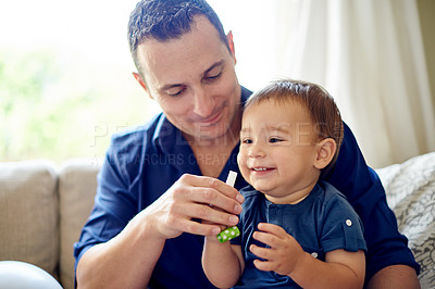 Buy stock photo Birthday, blower and smile of dad with son on sofa in living room of home for milestone. Development, growth or party whistle with boy child and single parent man in apartment for bonding as family