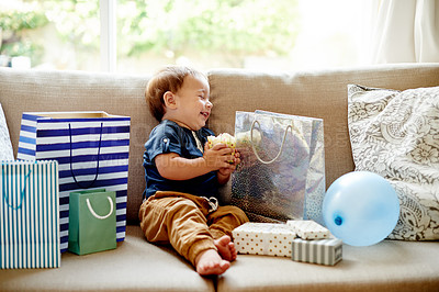 Buy stock photo Happy toddler, birthday and cupcake with gifts on sofa for party celebration or surprise in home. Boy, kid or child with smile, gratitude or thankful for presents, boxes or dessert snack in house