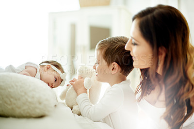 Buy stock photo Family, mom and teddy bear for baby, bedroom or bonding with children, flare and affection in house. Happy, boy and playing with sister, woman and single parent with kids, love and care in home