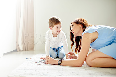 Buy stock photo Mom, son and puzzle for learning with education toys, development and bonding in home. Woman, child and help with growth, support and love or logic activity for academic games on bedroom floor