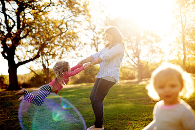 Buy stock photo Mom, spin girl and excited at park with game, bonding or lens flare with love, care and summer in nature. People, mother or daughter in garden with smile, swing and play for family fun in New Zealand
