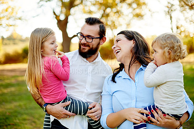 Buy stock photo Happy family, outdoor and sunlight in park, care and hug for love connection. Smile, parents and young children in summer outing trip with bonding, support and trust for special memory together.