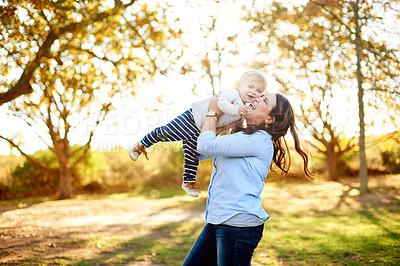 Buy stock photo Mom, happy and lift baby at park with care, love and excited for play, fun and outdoor in summer. People, mother and daughter with games, smile or toddler child with memory in garden in New Zealand