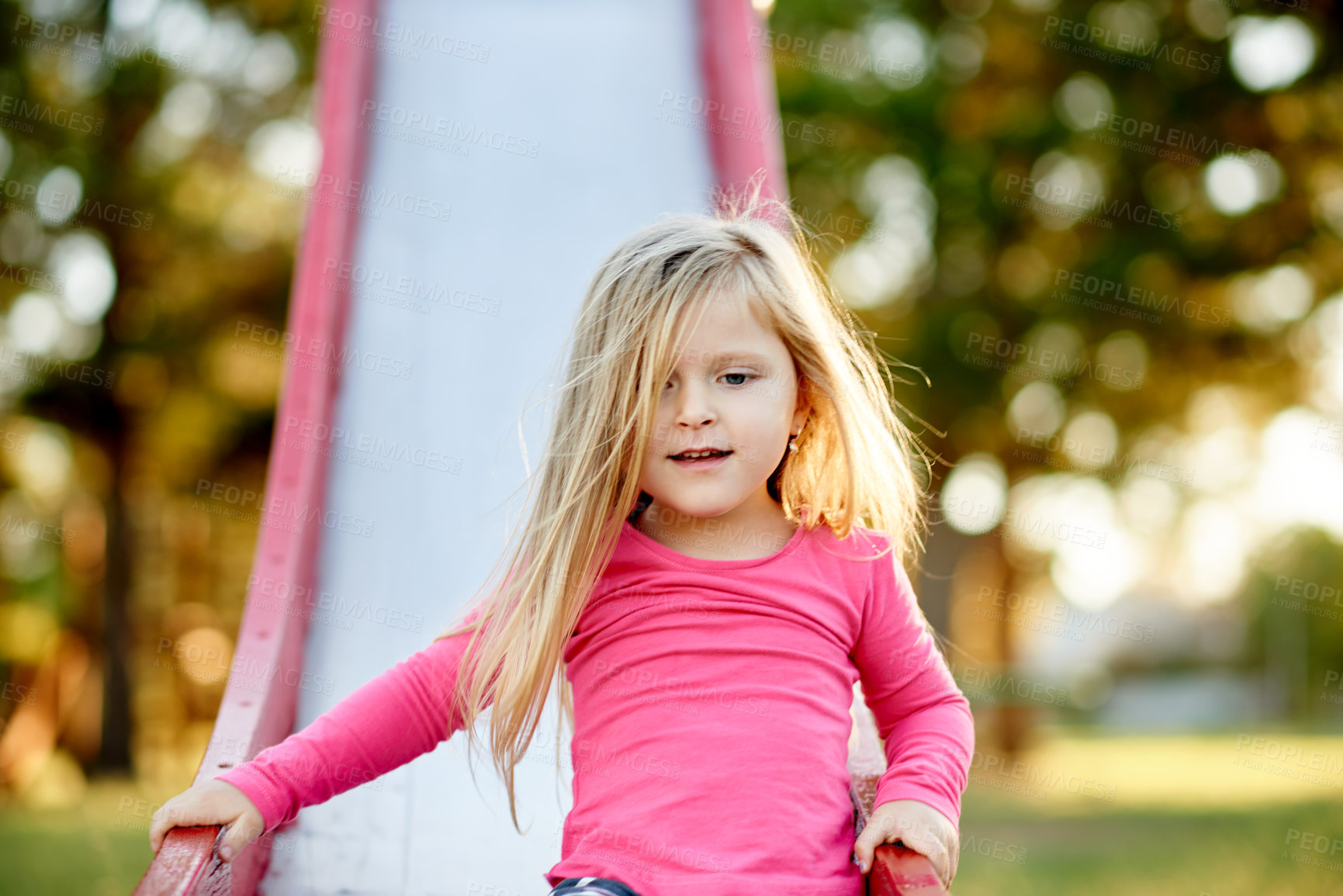 Buy stock photo Outdoor, slide and child in park for holiday, weekend or adventure for fun with development. Smile, cute and girl kid for playing in nature on playground for hobby on equipment in summer with freedom