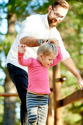 Buy stock photo Playground, happy and dad with girl in park for bonding, playing games and having fun. Family, sunlight and father with child for help, support and relax on holiday, adventure and activity on weekend
