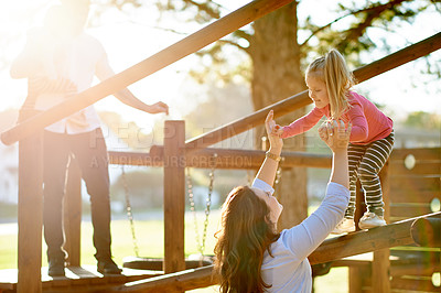 Buy stock photo Playground, happy and parents with kids in park for bonding, playing games and having fun. Family, sun flare and  child for help, mom and dad on holiday, adventure and activity on weekend outdoor