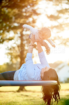 Buy stock photo Family, fun and child with mom, playground or lifting on merry go round, woman and toddler in nature. Outdoor, park and break with girl on weekend, childcare and play with daughter, bonding and game